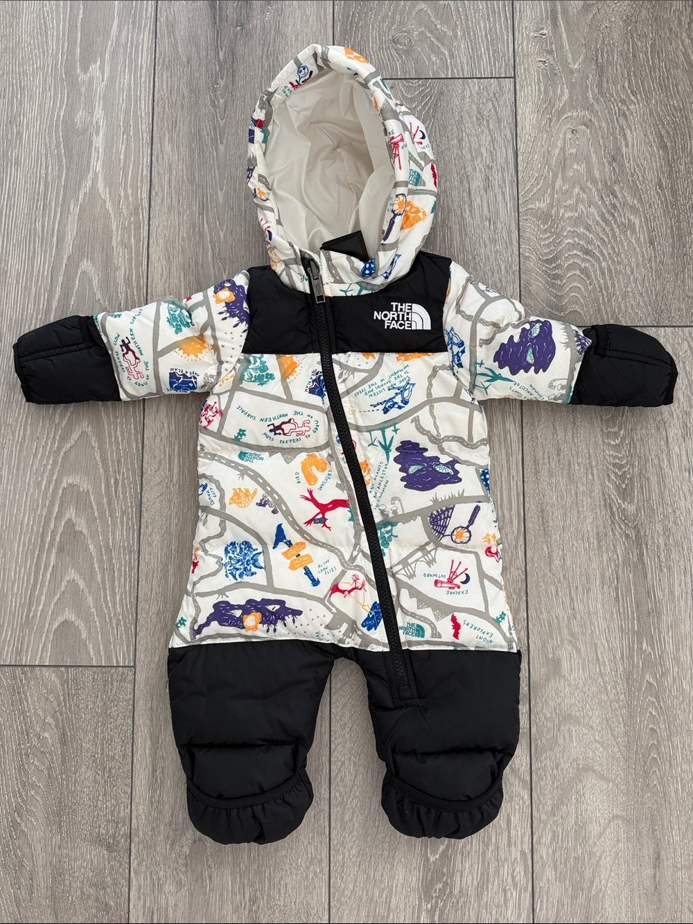 The North Face Infant Hooded Snowsuit in White with Black and Multicolor Print